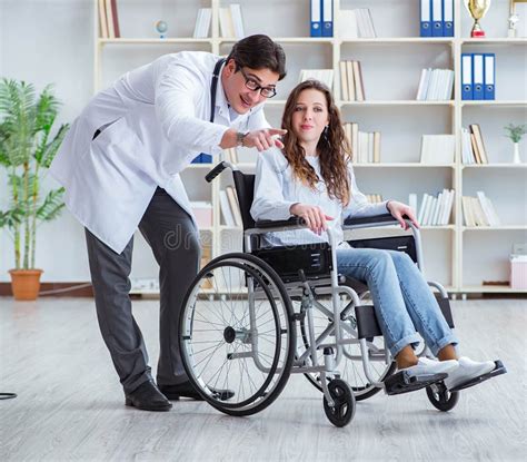 Disabled Patient On Wheelchair Visiting Doctor For Regular Check Stock