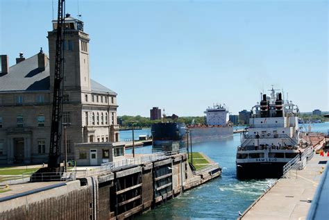two large ships are docked in the water next to a building and another