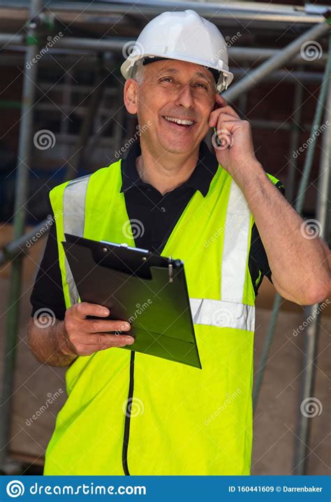 Male Builder Foreman Architect Contractor On Building Site Using Phone ...