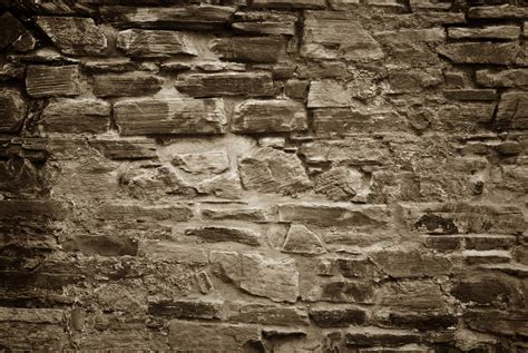 Old Stone Brick Wall Background In Sepia