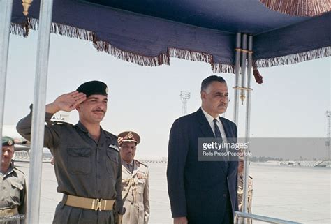 King Hussein Of Jordan Salutes As He Watches A Military Welcoming