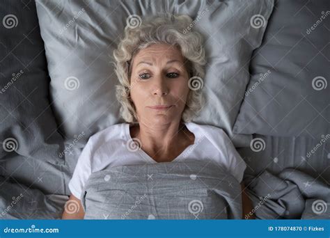 Unhappy Mature Old Grandmother Suffering From Insomnia At Night Stock