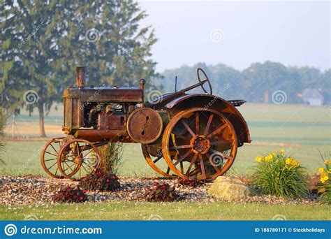 Rusty Vintage Farm Tractor Display Rural Farm Bright Flowers Stock