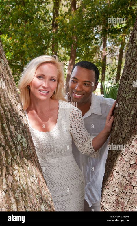 Romantic Portrait Of Mixed Race Couple In Park With Black Man And