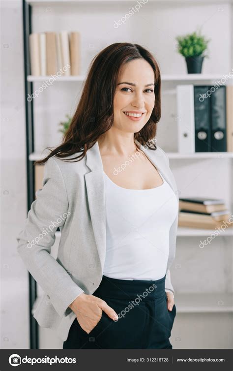 Attractive Smiling Secretary Looking Camera While Standing Hands
