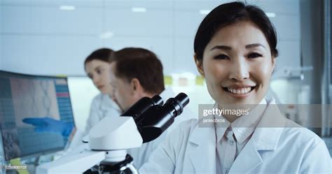 Asian Female Scientist Satisfied With Her Work Futuristic Genetic Research Laboratory High Res