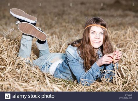 Download This Stock Image Portrait Of Teenage Girl Lying On Field