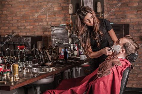 Female Barber Shaving A Client In A Barber Shop Stock Photo By ©guruxox