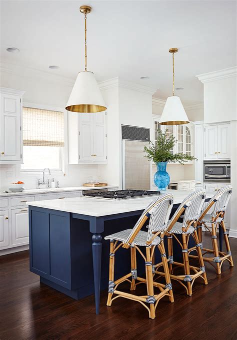 This blue note by benjamin moore painted island gives a pop of color to this lake house kitchen. Amie Corley Interiors | House of Turquoise