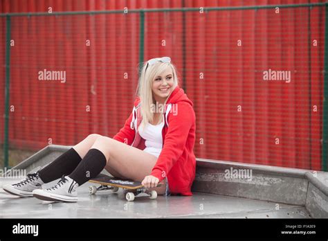 Pretty Teenage Girl Wearing Denim Shorts Sitting Down