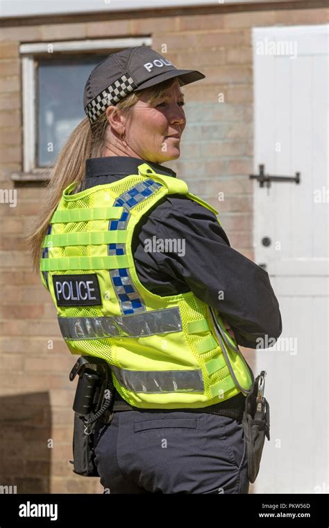 Portrait Of A Policewoman In Uniform Standing At A Crime Scene Stock