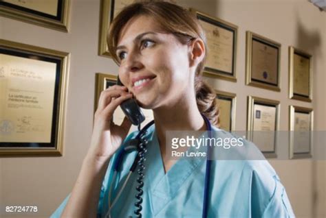 Nurse Answering The Phone At Reception High Res Stock Photo Getty Images