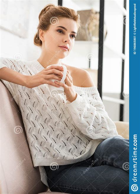 Woman In White Sweater Holding Cap And Looking Away Stock Image Image