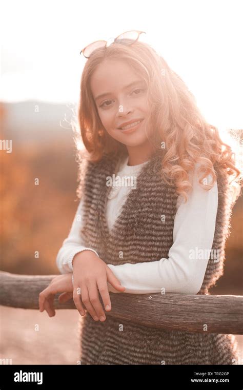 Smiling Teen Girl 13 14 Year Old Posing In Sun Light Outdoors Wearing Casual Autumn Clothes