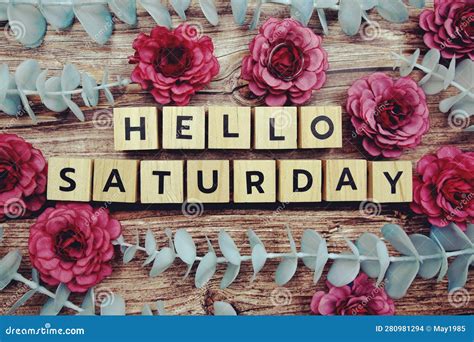 Hello Saturday Alphabet Letter And Flower Decorate On Wooden Background
