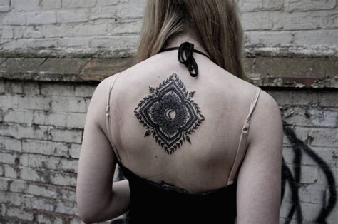Ornamental Style Tattoo On The Upper Back