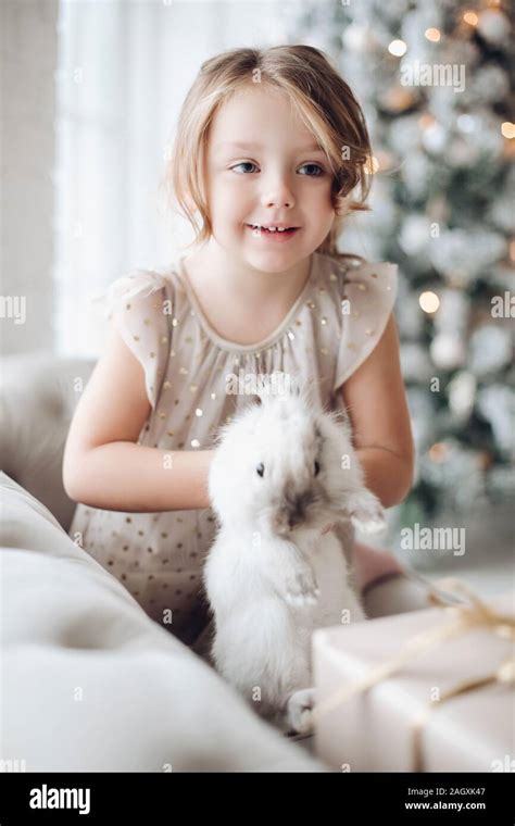 Adorable Girl With Bunny In Hands Adorable Young Girl Smiling Away In