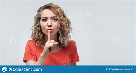 Portrait Of Pretty Blonde Girl Holding Index Finger On Lips Silence And Secret Concept Copy