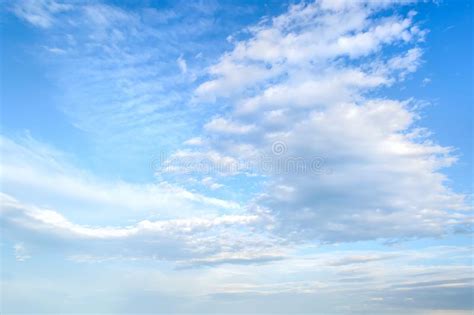 White Light Fluffy Stratus And Cirrus Clouds High In The Blue Summer