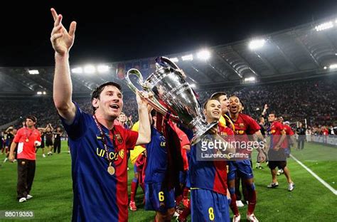 Lionel Messi Of Barcelona Lifts The Trophy As He And His Team Mates
