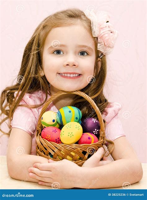 Cute Smiling Little Girl With Basket Full Of Easter Eggs Stock Photo