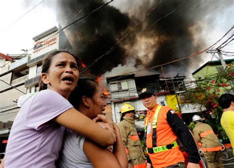 Devastated Women Watch Their Homes Burn In Manila Slum