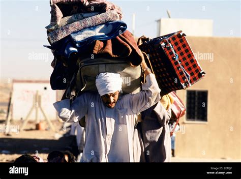 Refugee Man Carrying All His Luggage During Gulf Crisis Stock Photo