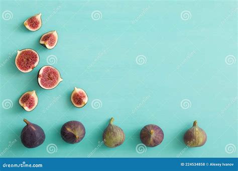 Top View On Sliced And Full Fresh Figs On Turquoise Wooden Table Or