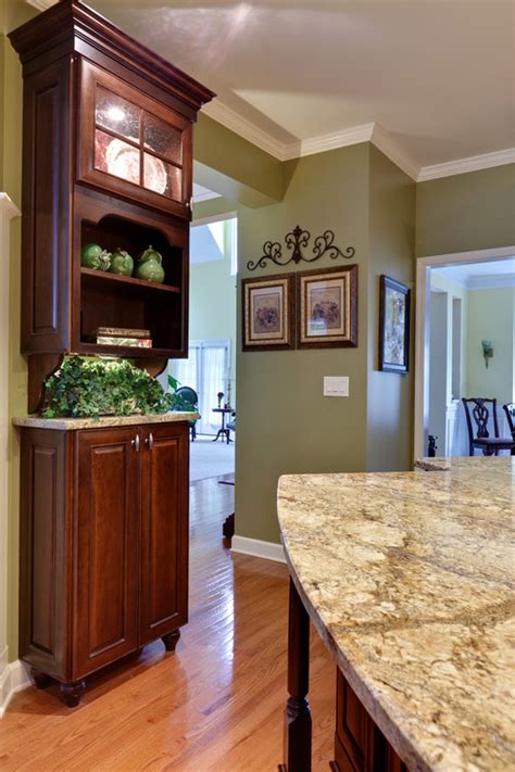 Cherry kitchen cabinets combined with brazilian cherry wood flooring, a black granite countertop and a black glass chandelier complete this transitional if you're planning a kitchen redesign, your cabinet material choice will be one of the biggest decisions you'll have to make—and you may need to look no. love the green paint with the cherry cabinets. will you ...