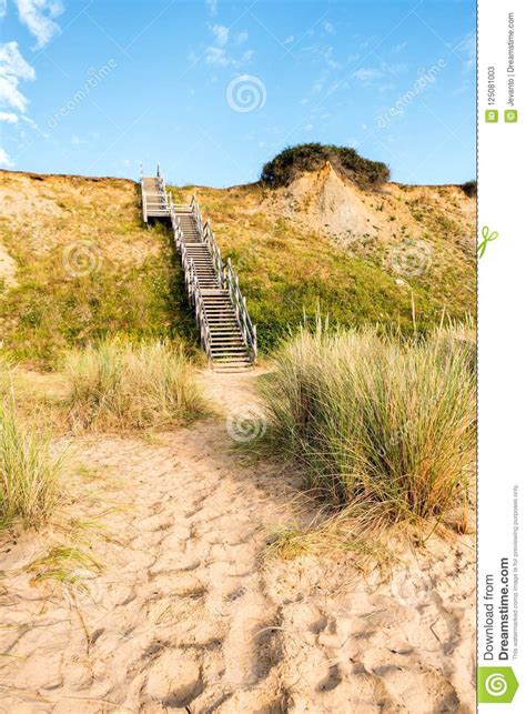 Wooden Steps Heading Up To Hill On Seaside Beach And Sand Dunes At