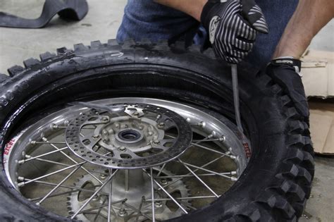 Hook the rounded end of one tire lever under the bead (the outer edge) of the tire to unseat it. How to mount heavy duty ice tires on a dirt bike - DIY ...
