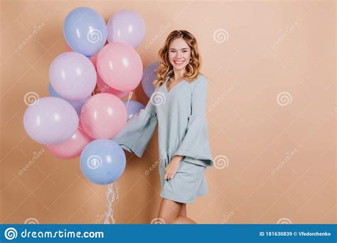 Happy Young Lady In Trendy Blue Dress Posing With Party Balloons