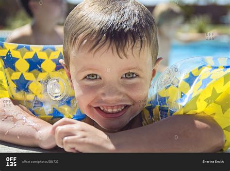 Boy Wearing Arm Floaties In A Swimming Pool Stock Photo Offset