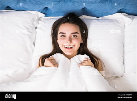 Girl Hides Her Face In Bed Cheerful Girl In Bed Hiding Her Face Under The Blanket Teenage Girl