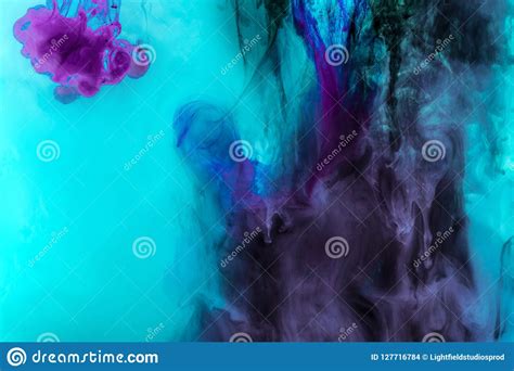 Creative Texture With Turquoise And Purple Swirls Of Paint In Water