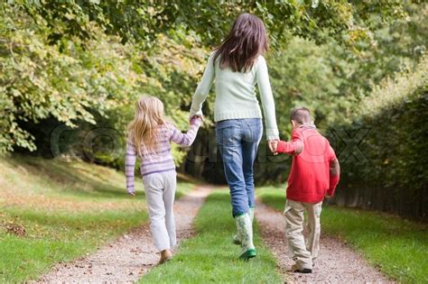 Mother And Children Walking On Woodland Stock Image