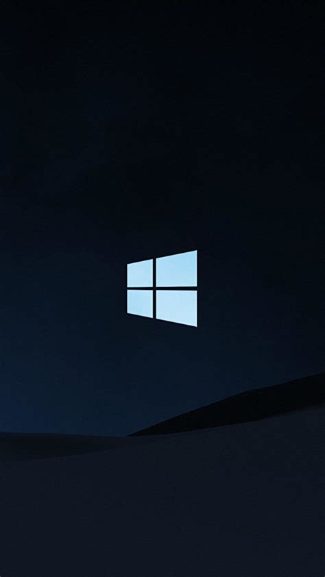 The Windows Logo Is Lit Up In The Dark Sky Above A Desert Landscape At