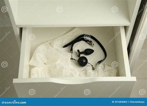 Anal Plug Ball Gag And Women S Underwear In Open Drawer Of Nightstand Indoors Closeup Sex
