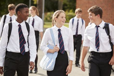 Group Of Teenage Students In Uniform Outside School Buildings Stock