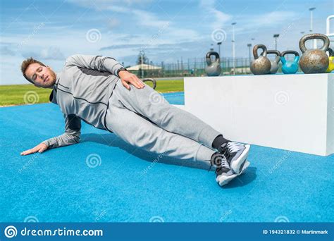 Planking Fitness Man Doing Side Plank Exercises At Outdoor Gym Training