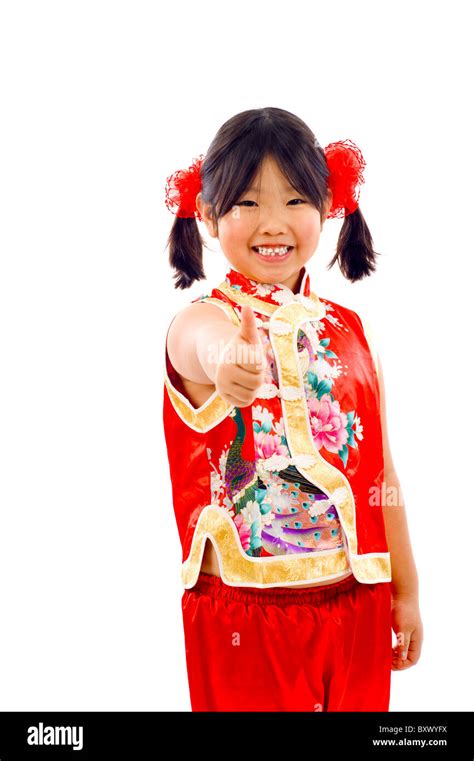 little asian girl making thumbs up sign chinese new year she s weaing traditional chinese red