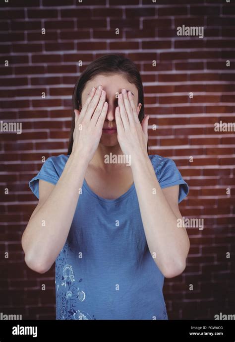 Pretty Brunette With Hands Over Eyes Stock Photo Alamy