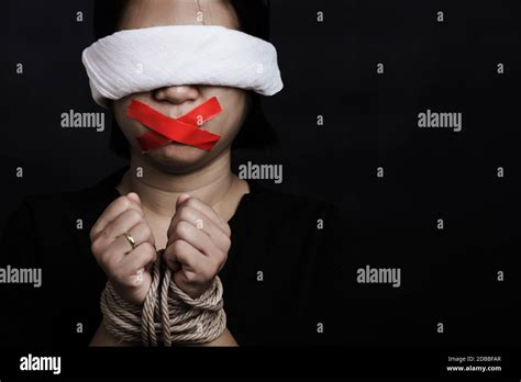 Slave Asian Woman Blindfold Wrapping Mouth With Red Adhesive Tape Tied With Chains And Closed
