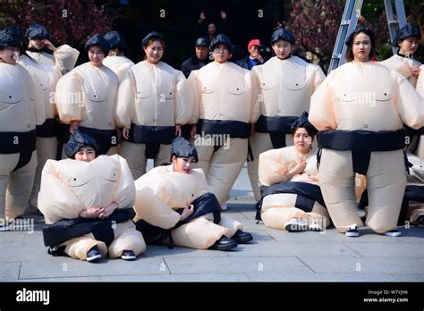 Chinese Women Dressed In Inflatable Sumo Wrestler Costumes Pose At
