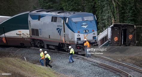 Work Crews Survey The Scene Of An Amtrak Train Derailment On December