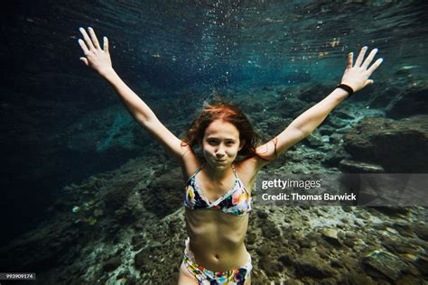 Underwater View Of Smiling Girl Holding Breath While Swimming