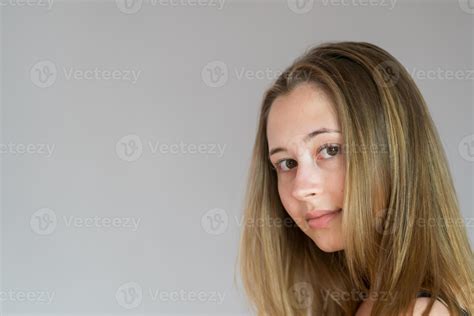 Close Up Studio Portrait Of A Young Back Turned Woman Turning Her Head