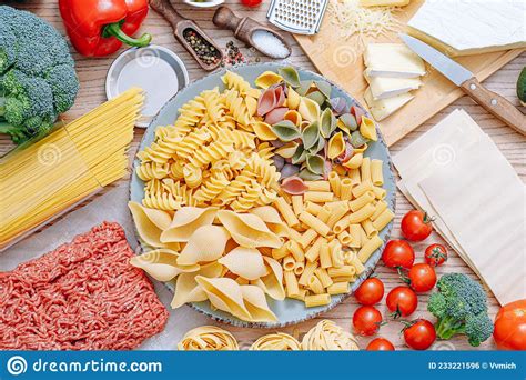 Different Types Of Italian Pasta On A Wooden Background With Various