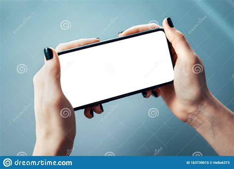 Close Up Image Of Female Holding Smartphone Horizontally With Both