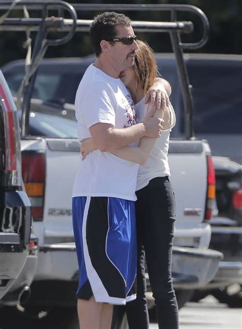 adam sandler shares a pda with his wife jackie as they enjoy a